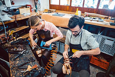 Sabian Symbol for Taurus 29: Two cobblers working at a table.